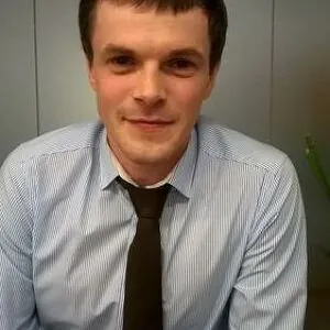 Man with a blue suit and black tie
